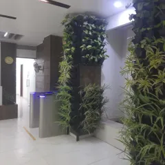 I bring nature indoors to make office spaces better. This vertical garden pillar at Era Infra Eng. Ltd. uses air-purifying plants to create a healthier and more welcoming lobby area.