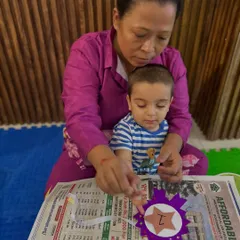 The bond between a child and their caregiver is at the center of everything we do. This quiet moment of a grandparent and toddler working together on an arts and crafts project shows the focus and connection that our activities foster.