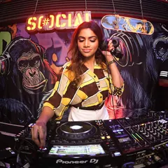 In my element behind the decks at The Grind. This is my command center, where I mix the bangers and keep the party moving. It’s all about reading the room and dropping the right track at the right time.