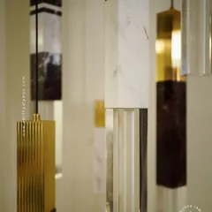 A collection of our pillar pendants, which combine sections of solid marble, fluted metal, and clear crystal. These substantial, high-quality fixtures can be hung individually or in clusters to create a dramatic effect in stairwells or entryways.