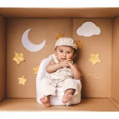 Dreaming among the stars. This 'in the box' setup with a moon and stars theme is perfect for a whimsical and creative milestone photo.