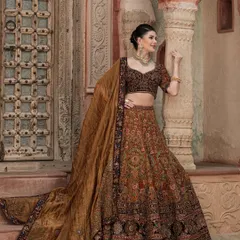 The full, majestic look of our brown bridal lehenga from "The Bridal Saga". The flowing dupatta and detailed embroidery create a truly regal silhouette.