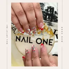 A creative twist on a French manicure, featuring tiny, hand-painted strawberries and a bold red tip. This design, created by our artist Eli, shows how we can personalize a classic look with charming details.