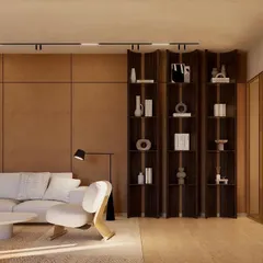 A custom-designed shelving unit acts as both a display and a subtle space divider in the informal living area. The dark wood contrasts beautifully with the neutral tones of the room.
