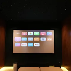 The Apple TV interface on the large screen in the Nellore project. The starlight ceiling and hidden perimeter lighting create a clean, modern look.