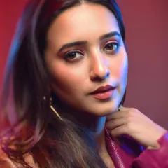 Using a softer focus can add a different feel to a cinematic portrait. The blend of red and blue light combined with the model's gentle expression creates a more romantic and thoughtful mood within the same series.