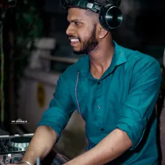 Here I am in my element, doing what I love. A good DJ doesn't just play music; I connect with the crowd, feel the energy, and make sure everyone is having an unforgettable time. This is a typical shot of me at a night event, focused on the mix.