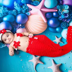 Let's dive into a world of imagination. This little mermaid is enjoying her magical underwater world, a custom theme I designed with colorful props and a knitted mermaid tail to make her dreams come true.