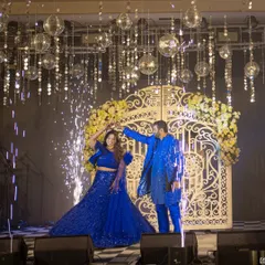 A picture-perfect moment for the couple on their sangeet night. They share a dance under a canopy of hanging disco balls and crystals, with cold pyros adding a touch of sparkle to their performance.