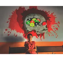This edgy skull mural was designed for a snooker club. The design incorporates billiard balls into the skull's brain, creating a clever and visually striking piece.