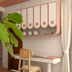 A dedicated study area is essential. This custom desk is paired with playful, curved overhead storage and a versatile pegboard wall, providing a perfect spot for creativity and focus that can be personalized over time.