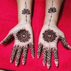 This striking design features a lotus mandala on the palm and a single lotus motif on the wrist, connected by a simple line. It's a perfect example of elegant minimalism.