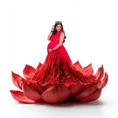 A vibrant fantasy portrait featuring a mom-to-be in a red gown, seated within a giant red lotus flower. This unique and artistic concept makes for a stunning and memorable photo.