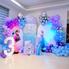 A spectacular 'Frozen' themed birthday party. I used shades of blue, purple, and silver balloons to create a winter wonderland, complete with character cutouts of Anna and Elsa, a sequin backdrop, and a giant light-up number three.