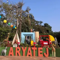 For this 'Wild Two' jungle themed birthday, we created a massive custom stage with marquee letters, a waterfall feature, and life-sized animal props to serve as the perfect backdrop for the celebration.