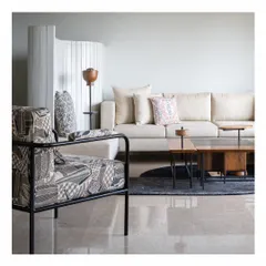 This living room in our Powai House project is a study in texture and form. A custom-patterned armchair sits beside a plush, neutral sofa, creating a dynamic yet balanced composition. The space is designed to feel open and airy, a calm retreat within a bustling urban environment.
