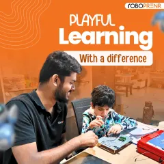 Our learning environment is designed to be playful and encouraging. Here, one of our instructors provides one-on-one guidance to a young student, fostering a love for technology through hands-on projects with circuits and electronics.