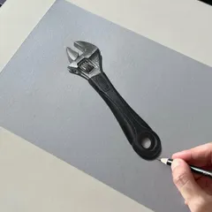 This is a realistic drawing of a spanner. Capturing the texture and reflections of worn metal is a great exercise for any artist.