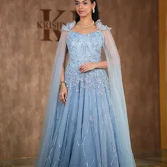 A fairytale moment in this powder blue gown with a sheer cape. The simple diamond necklace adds a touch of elegance, making it perfect for a reception or pre-wedding photoshoot.