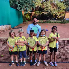 My mini tennis group posing with their coach. The goal of the Junior Kickstart program is to create a positive and encouraging first experience with tennis.