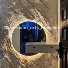 A full view of the rock texture mural with the integrated backlit mirror. It serves as both a vanity area and a piece of sculptural art, setting a sophisticated tone for the home.