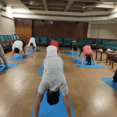 Here is a glimpse of an in-person teacher training session at my Noida center with students from around the world. We focus on correct alignment and form, such as in Adho Mukha Svanasana (Downward-Facing Dog), in a supportive group environment.
