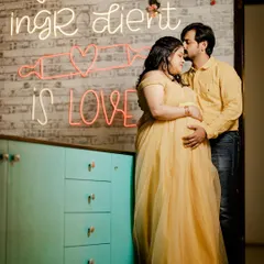 A gentle forehead kiss in front of a modern neon sign. This shot blends tenderness with a cool, contemporary studio backdrop for a unique couple's portrait.