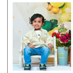 This toddler looks so confident and happy in his casual outfit for his second birthday shoot. These sessions are all about letting their growing personality shine.