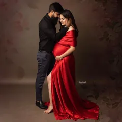 Capture the passion and intimacy of your journey with our bold red satin mermaid gown. Its vibrant color and sleek fit beautifully highlight your baby bump, making for powerful and romantic couple portraits.