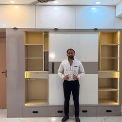 Here I am with a newly installed sliding wardrobe. The dual-tone design with integrated lighting provides ample storage while adding a modern touch to the bedroom.