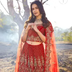 A closer look at the stunning craftsmanship on this red bridal lehenga. The delicate work on the blouse and the flow of the skirt are designed for a timeless bridal portrait.