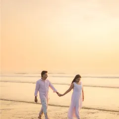 A classic romantic pre-wedding portrait taken during the golden hour at the beach. I use the soft, warm light of the sunset to create a dreamy and timeless image that focuses on the simple joy of a couple walking hand-in-hand by the sea.