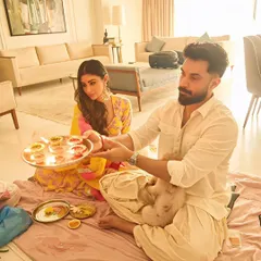 A heartfelt ritual unfolds in front of one of our paintings in Mouni Roy's home. Art is not just decoration; it becomes part of the life and memories created within a space.