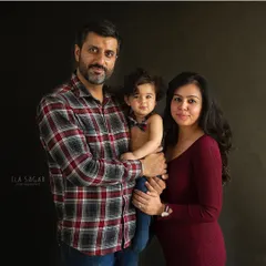 A classic family portrait. Everyone is looking at the camera, creating a timeless photo that will be treasured for years to come.