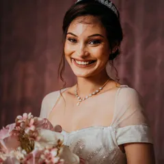 The pure joy of a bride on her wedding day, her smile lighting up the room. This candid portrait captures her happiness and excitement perfectly.