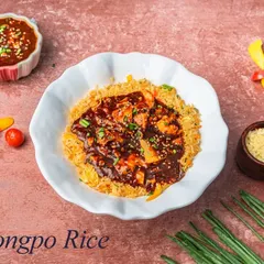 Dongpo Rice is a savory dish featuring a bed of crispy noodles and rice topped with chicken or vegetables in a rich, dark, and flavorful sauce. It's a complete meal in a bowl.