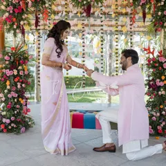 The exchange of rings is a pivotal moment. We ensure the backdrop, with its hanging floral strings and vibrant blooms, is as beautiful as the memory you're creating.