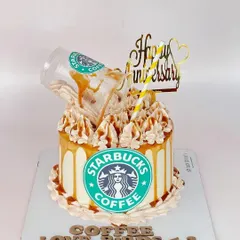 For the coffee-loving love birds! This fun Starbucks-themed anniversary cake features a gravity-defying coffee spill, caramel drizzle, and the iconic green logo.
