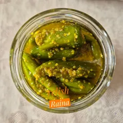A single jar of my Stuffed Green Chilli Pickle, showing how the chillies soften and absorb the flavours of the masala and mustard oil over time. This pickle is medium spicy and is a perfect side for parathas or mathris.