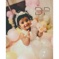 A portrait from a first birthday photoshoot, capturing a beautiful, happy expression. I aim to make these sessions fun for the little ones, resulting in genuine smiles and sparkling eyes.