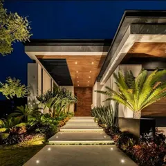 I believe architecture should be as captivating after dark as it is in daylight. For this modern residence, I designed a multi-layered lighting scheme that accentuates the clean lines of the facade, illuminates the tropical landscaping, and creates an inviting, dramatic entryway.