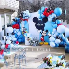 Oh boy! A classic Mickey Mouse party is always a hit. This fun setup uses Mickey's iconic colors with blue, red, and polka-dotted balloons, along with character cutouts for a timeless birthday celebration.
