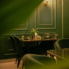 Another perspective of the dining area, showing the warm lighting and sophisticated wall molding.