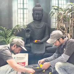 Our murtikars are seen here adding the final touches to a 4-foot black marble Buddha statue and uruli set. This image captures the dedication and artistry that goes into every hand-carved masterpiece.