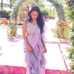 The pre-draped ruffles on this lavender saree create beautiful texture and movement. It’s a modern, feminine, and incredibly easy-to-wear option for any celebration.