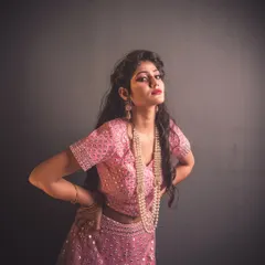 Using a single light source, I created this dramatic, high-contrast fashion shot. The spotlight effect highlights the model and her pink lehenga, making her stand out against the dark background with a theatrical flair.
