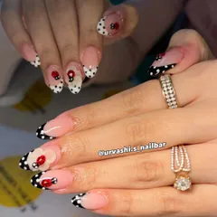 This cute and classy set features hand-painted polka dots and tiny ladybugs. The design uses a modern French tip style in black and white, with the playful bugs adding a whimsical touch.