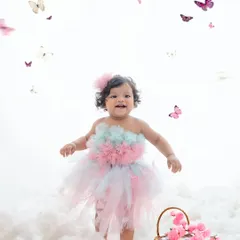 Walking on clouds and surrounded by butterflies, this little girl in her pastel tutu is living in a fairytale.