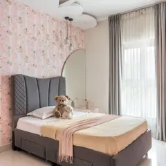 This daughter's bedroom in 'The Flux Abode' is a pink-hued dreamscape. It features a cloud-shaped false ceiling and whimsical koala-print wallpaper for a playful touch.