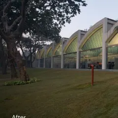 The "After" view of the transformed Okhla shed. The original arched bays are now filled with glass, opening the building to the landscape and creating a stunning architectural rhythm.
